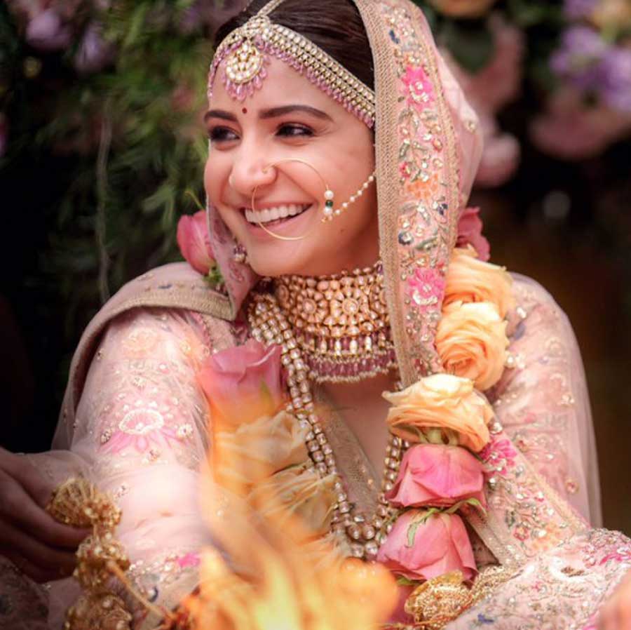 Anushka Sharma: Anushka was a prime mover for the pastel bride trend. She chose a pale pink lehenga with Renaissance embroidery in vintage English colours embellished with silver-gold metal thread, pearls and beads. The minimal makeup and pink accents in her jewellery made the whole look ethereal