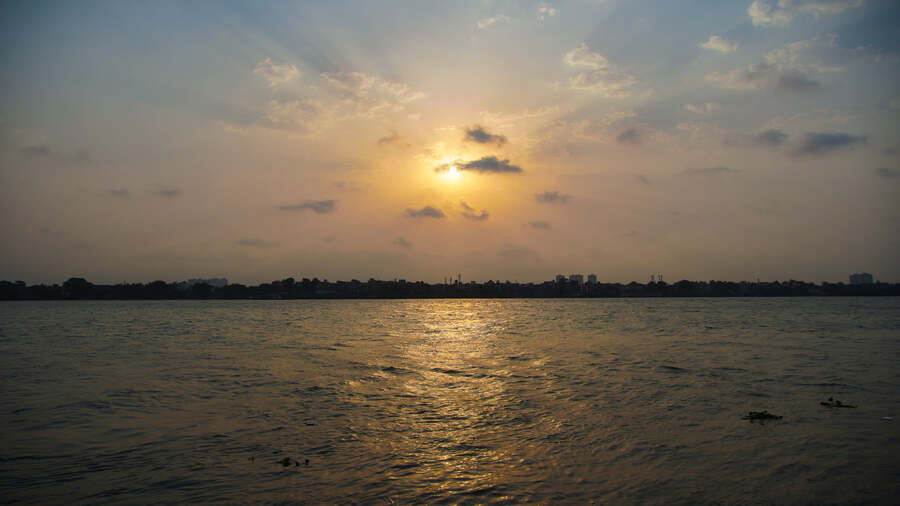 The sun peeps from behind clouds over the Hooghly river on the banks of the Ramakrishna Math and Mission world headquarters at Belur, Howrah, on Wednesday.  A cyclonic circulation had formed over Jharkhand on Tuesday, raising hopes of ending a prolonged 50-day-plus hot and dry spell in south Bengal.