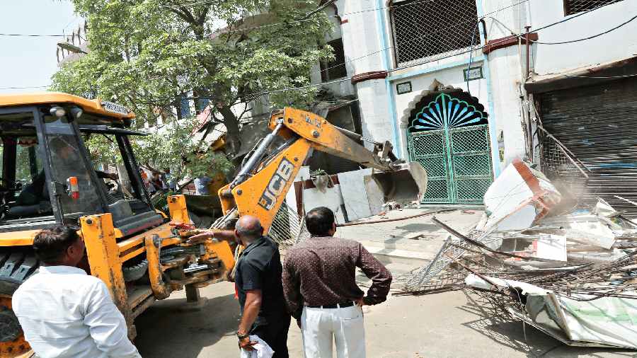 A portion of a mosque being  demolished.