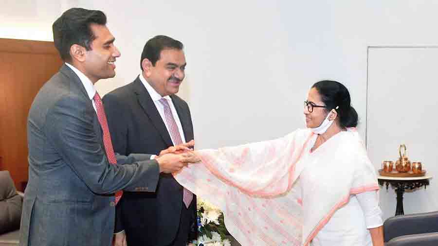 CM Mamata Banerjee greets industrialist Karan Adani and his father Gautam Adani at the Bengal Global Business Summit on Wednesday.