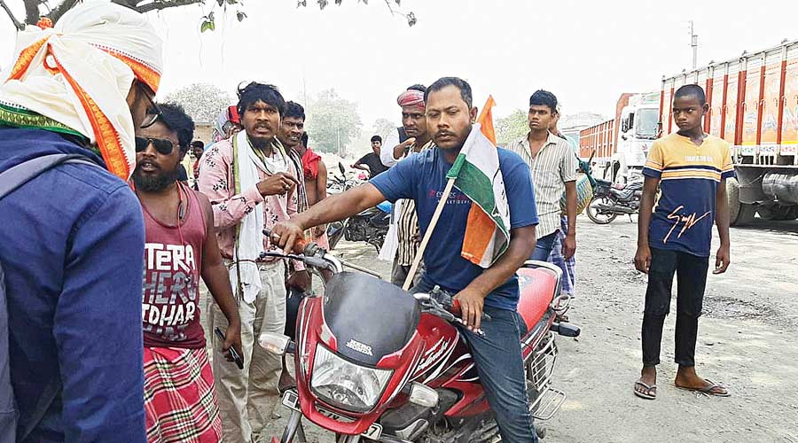 Tribal people guard one of the roads leading towards the protest stage in Deocha on Wednesday. 
