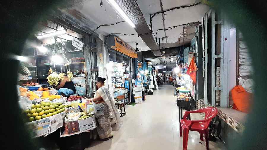 A lady shops for fruits in plastic bags in CA Market.