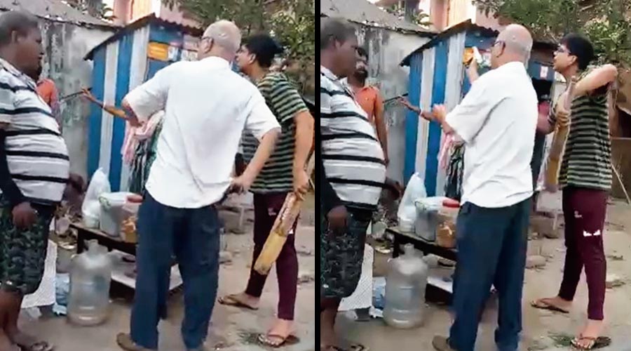 A video recorded by an eyewitness at Parnasree Pally on Thursday shows an elderly man, who police identified as factory owner Debasish Chakraborty, reaching for his pocket (left); The elderly man pulls out a pistol during an altercation with a hawker, who police identified as Bittu Das (in orange shirt)