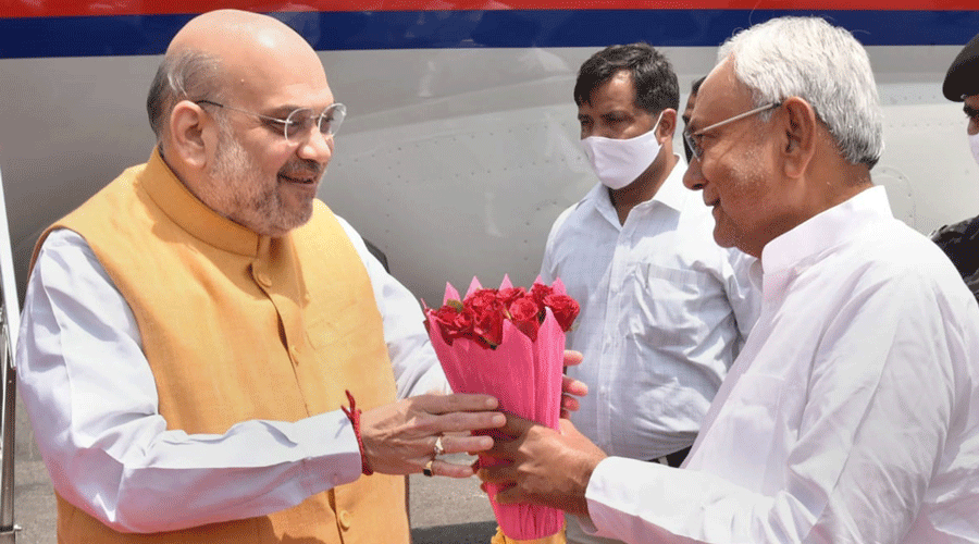 Bihar chief minister Nitish Kumar welcomes Union Home Minister Amit Shah at Japrakash Narayan Airport in Patna on Saturday.