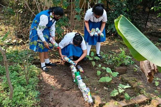 Students of Sacred Heart Convent, Jamshedpur, take part in eco brick fencing using used plastic bottles on Earth Day.