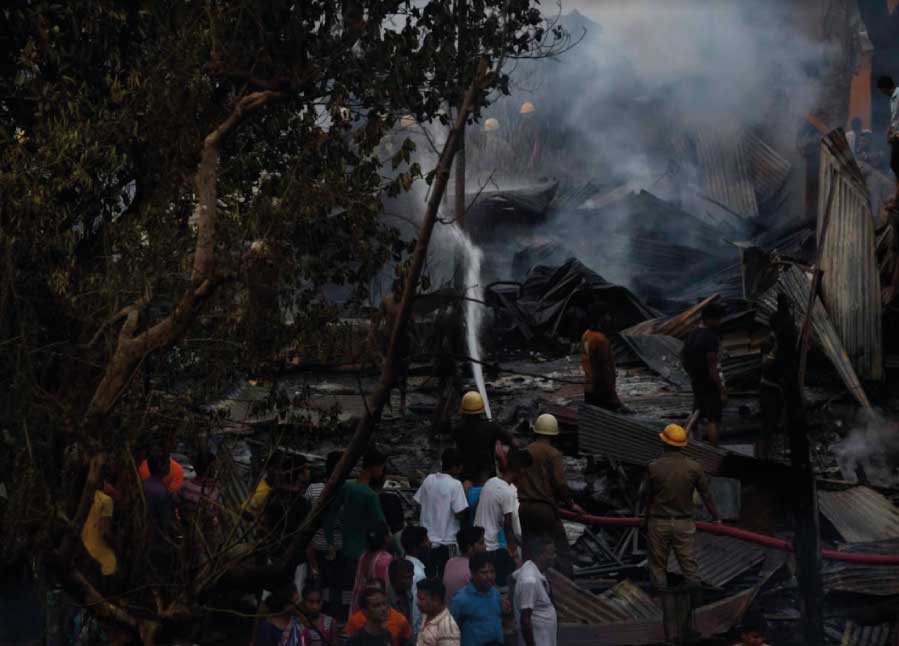 Firefighters spray water at the hot debris left in the wake of a fire in east Kolkata’s Tangra area on Sunday. The fire broke out at a car repairing-cum-maintenance garage on Christopher Road around 3pm. The police said no one was injured