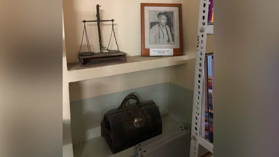 A niche for Nalini Kanta Sen, his portrait, medicine bag and the scales for the medicines he would prepare for his patients