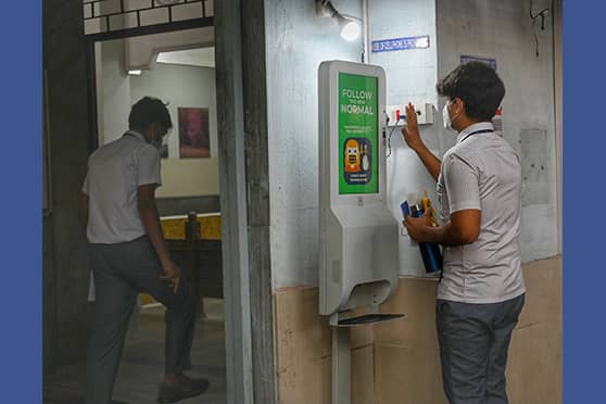 A student gets his temperature checked at a booth installed by the school. The device also includes a hands-free sanitiser dispenser. The CBSE board exams are being held offline after a pandemic break of two years. The board has instructed all schools to ensure strict implementation of COVID-safety protocol.