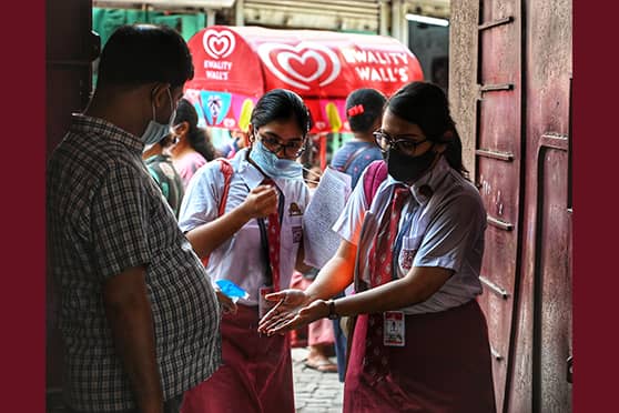 Students get their hands sanitised as they enter Calcutta Girls’ High School, an ISC examination centre.