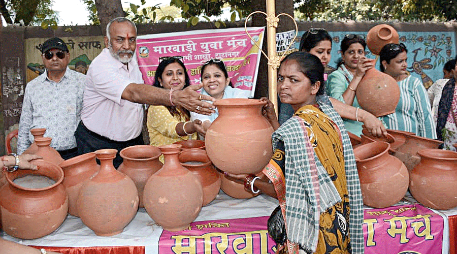 An NGO distributes earthen water pots among the poor in Jamshedpur on Tuesday.