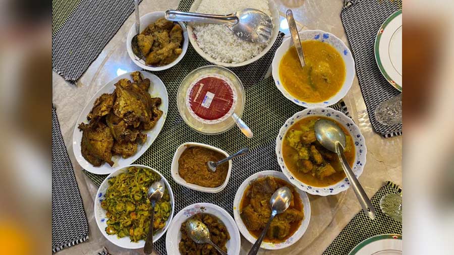 A dinner spread followed by Iftar containing uchche chingri bhaja, aam daal, shidol shutki bhorta, mutton bhuri bhaja and lots more