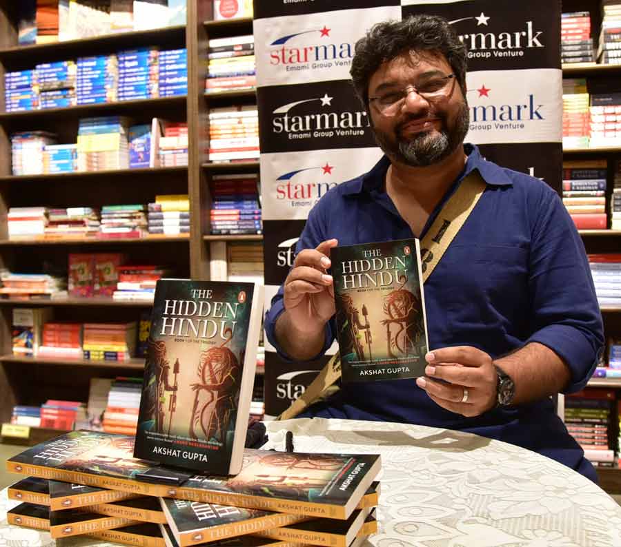 Author Akshat Gupta poses with his latest book ‘The Hidden Hindu’ at a promotional event at a city mall on Thursday. ‘The Hidden Hindu’ published by Penguin Random House India is an amalgamation of Hindu mythology and science fiction