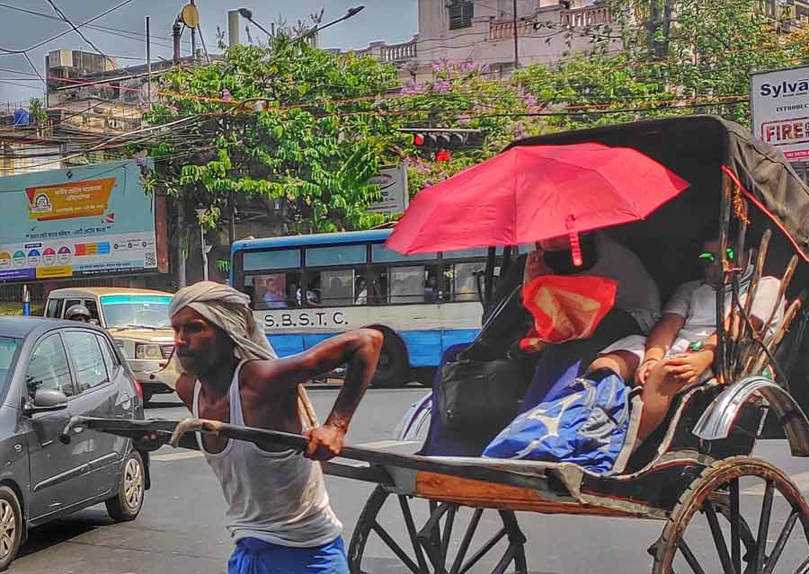 A guardian uses an umbrella to shield her ward from the scorching sun on Thursday. “Heatwave conditions are likely to prevail in several districts of south Bengal till April 30,” said an alert from the India Meteorological Department, Kolkata
