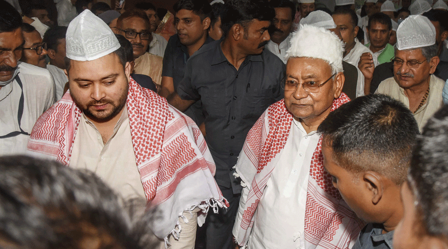Chief Minister Nitish Kumar with RJD leader Tejashwi Yadav during an Iftar party at Haj Bhawan in Patna on Thursday.