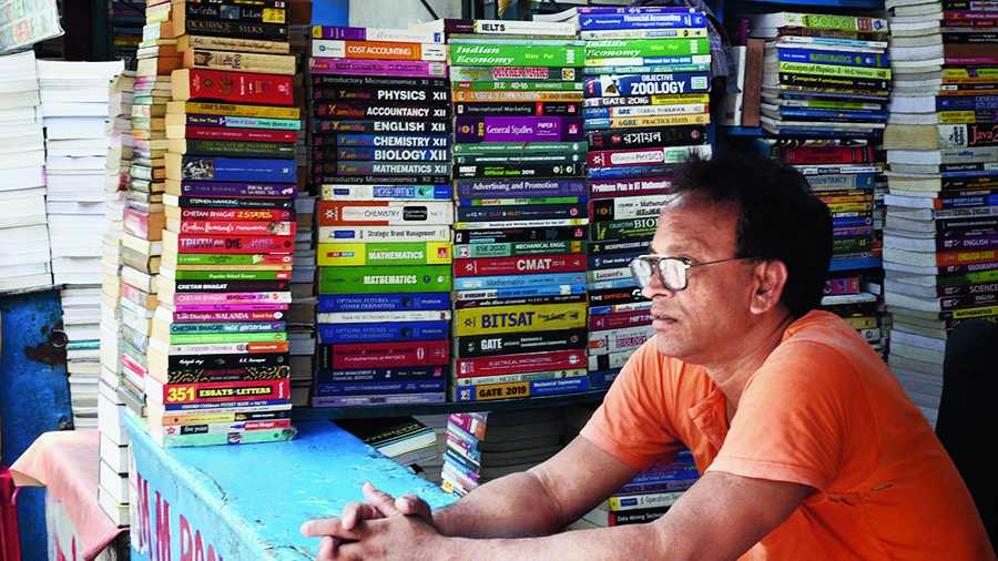 A book stall owner on College Street waits for buyers.