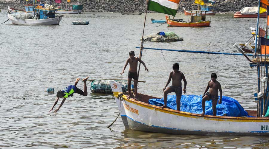 Boys jump into the Arabian Sea to beat the heat on a hot summer day, at Badhwar Park in Mumbai