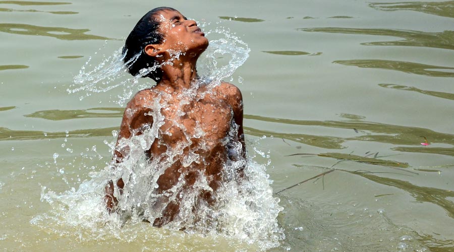 A boy takes a dip in a canal on a hot summer day, on the outskirts of Amritsar