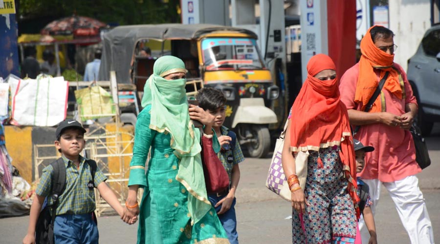 Commuters brave the scorching heat in Jamshedpur on Friday.