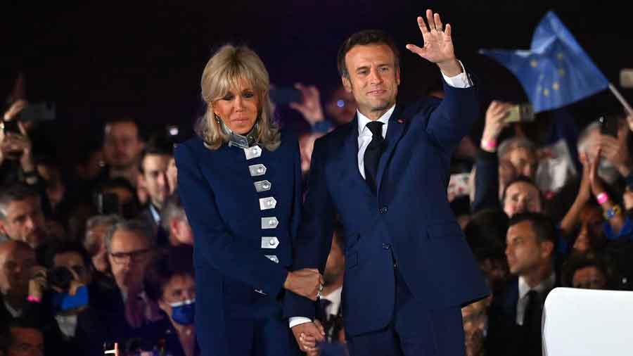 Macron and his wife at a party on election night April 24, wearing a suit by Jonas & Cie