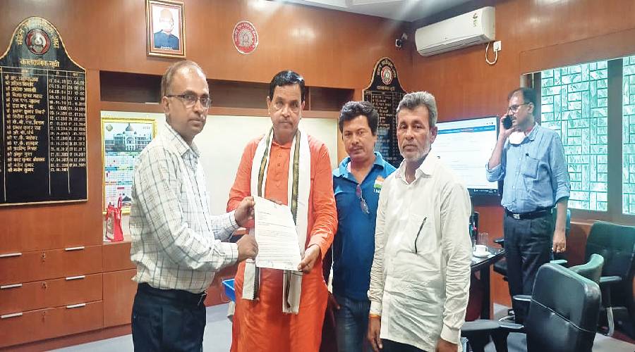 Amarnath Sakha (right) submits a memorandum to the Adra DRM, Manish Kumar. 