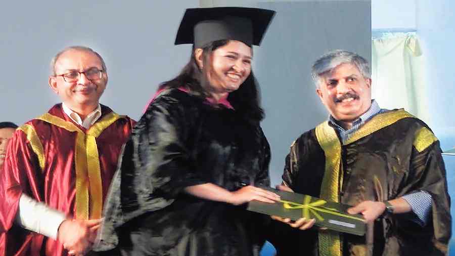 A student receives her MBA degree from Shrikrishna Kulkarni, chairperson, board of governors, IIM Calcutta, as director Uttam Kumar Sarkar looks on during the 57th annual convocation on Friday.