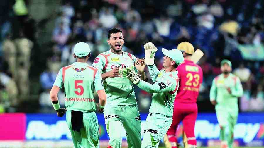Mohsin Khan celebrates with teammates after dismissing Punjab Kings’ Liam Livingstone, one of his three wickets, in Pune on Friday.