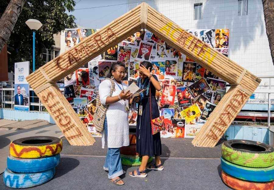 CINEPHILIA: Two women stand in front of an installation showcasing film posters at the Kolkata International Film Festival on Tuesday, April 26