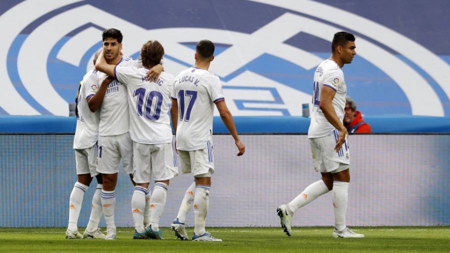 Real Madrid players celebrate after scoring a goal against Espanyol on Saturday