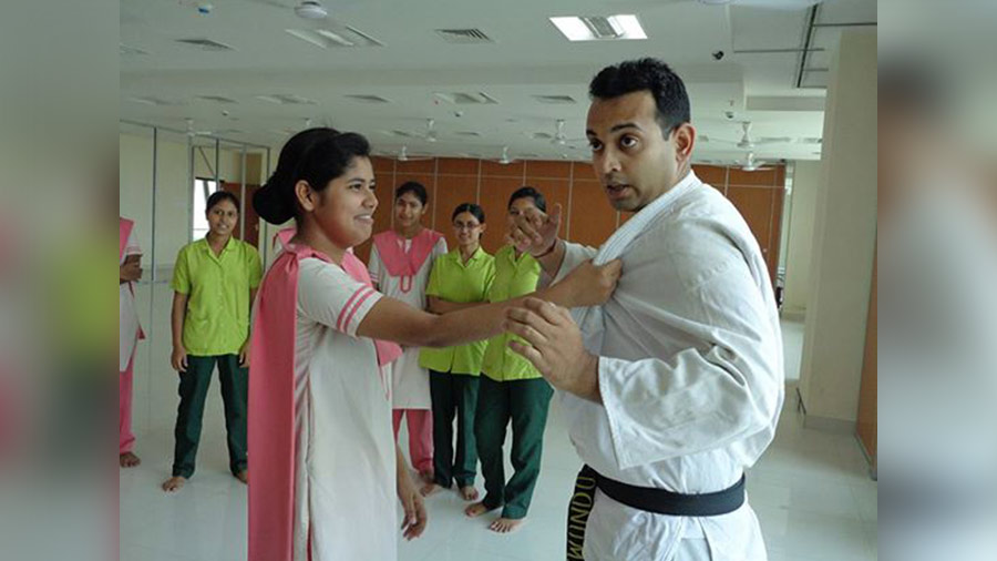 Gaurav Goswami teaches basic self-defence techniques to a school student