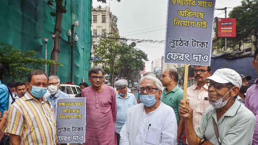 Left Front Chairman Biman Bose, CPM leader Surya Kanta Mishra and others participate in a rally to protest against SSC scam case in Calcutta on Monday
