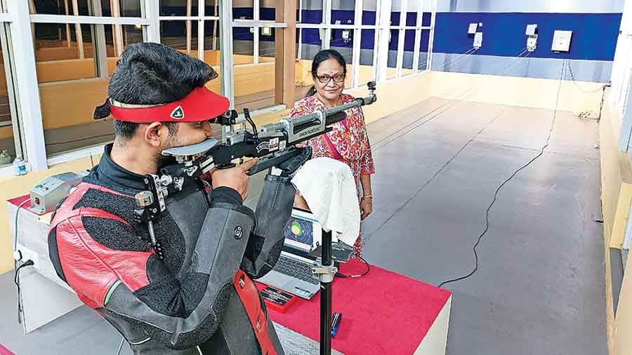 Jyotirmoyee Sikdar keeps an eye on her son as he practises in the range on the roof of her house in CL Block. 