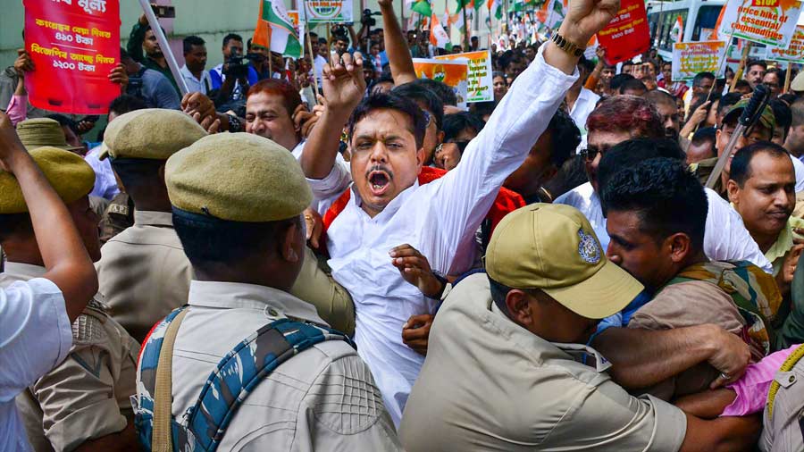 Police personnel in a scuffle with Congress leaders and workers during their protest over price rise and GST hike on essential commodities, in Guwahati on Friday.