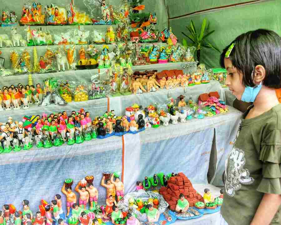 A girl looks at clay figurines on sale on Friday, ahead of Jhulan Purnima, which falls on August 12 this year 