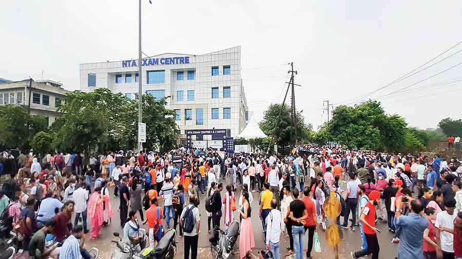 Students gather outside an exam centre in Noida on Friday after the National Testing Agency (NTA) cancelled the second shift of the CUET tests.