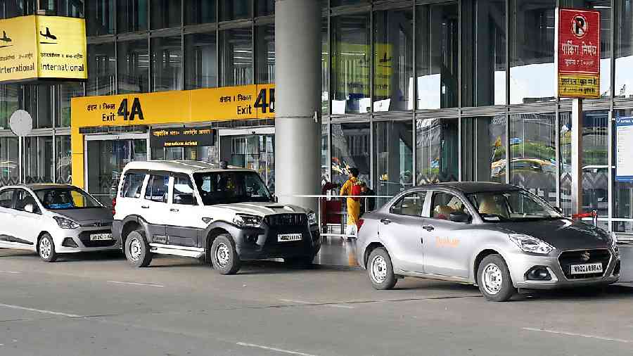 Vehicles parked on the road in front of the terminal building
