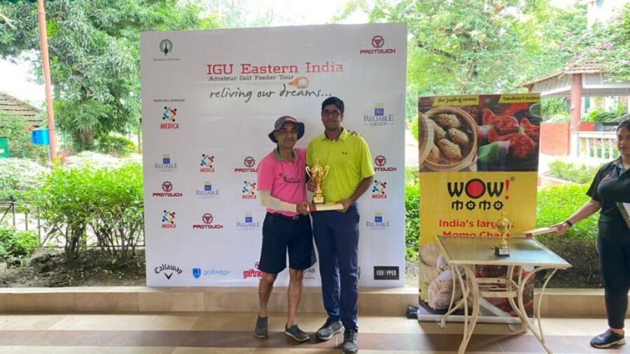 Kapoor collects his trophy from the tournament referee J.L. Roy