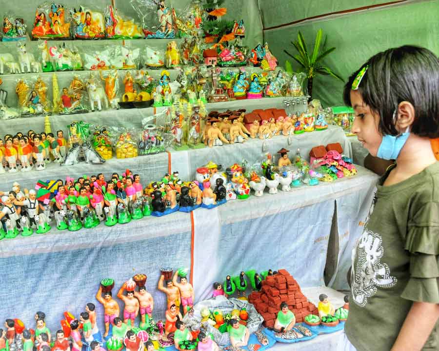 A girl looks at clay figurines on sale on Friday, ahead of Jhulan Purnima, which falls on August 12 this year. 