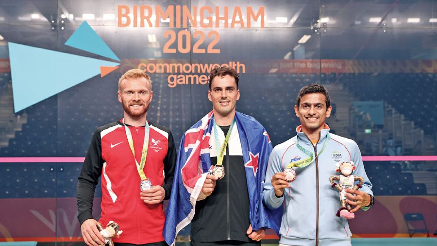 (L-R) Silver medalist Joel Makin of Team Wales, Gold medallist Paul Coll of Team New Zealand and Bronze medalist Saurav Ghosal of Team India pose on the podium during Men’s Singles medal ceremony on day six of the Birmingham 2022 Commonwealth Games at University of Birmingham Hockey & Squash Centre