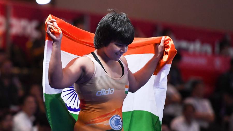 CWG 2022 bronze medal winning boxer Divya Kakran holding the Indian flag