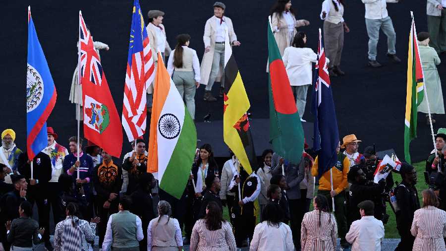 Flag Bearers of participating countries hold the national flags of their respective countries during the ceremony at Alexander Stadium. 