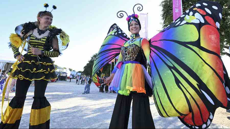 Stilt-walkers decked up in colourful clothes during the closing ceremony of the Commonwealth Games at Alexander Stadium. 