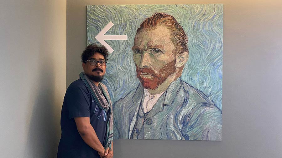 Sanatan Dinda at the Musée d'Orsay in Paris, in front of a portrait of Van Gogh, whose ‘The Starry Night’ is one of Dinda’s inspirations for this year’s Durga Puja