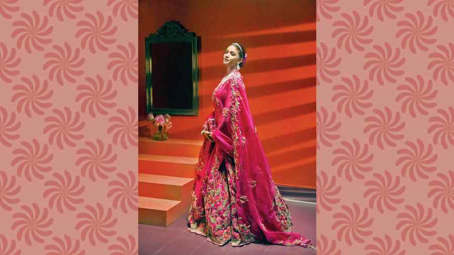 The Kamal Lehnga is a cute shade. “A lot of girls don’t want to wear a red lehnga. They want to wear pink, but not fluorescent pink. This lehnga has a tinge of red in it. Under different lighting, it looks different. When I started working, I used to work with lotus applique saris that I used to make on chiffon. People loved the motif of a lotus, traditional and dainty. I also used to make Benarasi fabric applique. I took inspiration from kimkhwab. This lehnga has nine-10 colours including the base colour and we have used French knots, threadwork and added a touch of gold,” says Eshaani.