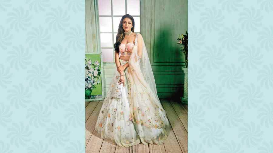 Eshaani has drawn inspiration from Downton Abbey for The Debutante Lehnga, which has georgette applique with French knots. The corset blouse makes for a striking pair. “The blouse is in keeping with a modern bride in mind,” says Eshaani.