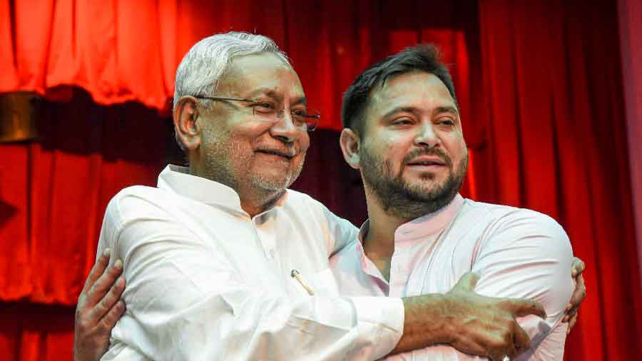 Bihar Chief Minister Nitish Kumar (L) with his Deputy Tejashwi Yadav after taking oath at Raj Bhavan in Patna on Wednesday