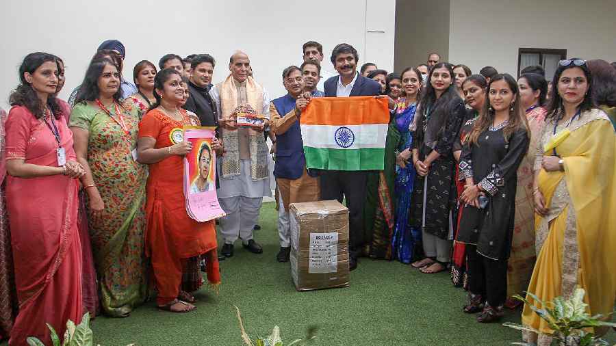 Defence Minister Rajnath Singh with members of a voluntary organisation who presented him rakhis meant for the Indian Armed Forces personnel