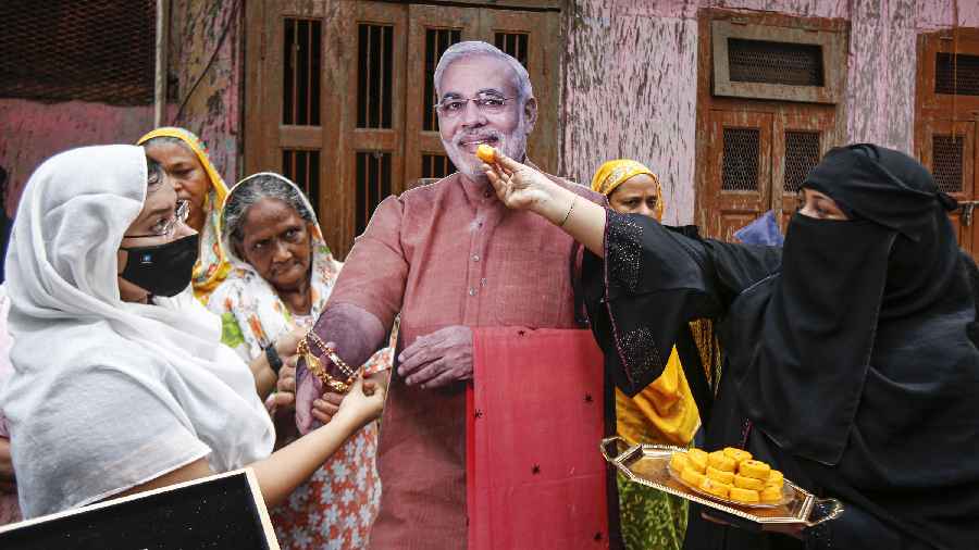 Muslim women symbolically celebrate Rakshabandhan with a cut-out of Prime Minister Narendra Modi in Ahmedabad 