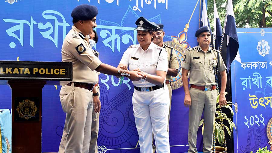 An Winners officer ties rakhi on the wrist of Kolkata Police commissioner Vineet Goyal.