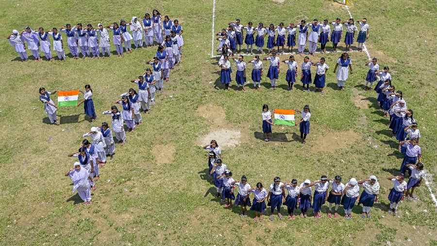 Students make a human chain in a formation that reads 75 as they celebrate 'Azadi Ka Amrit Mahotsav’ ahead of Independence Day, in Nadia district, West Bengal
