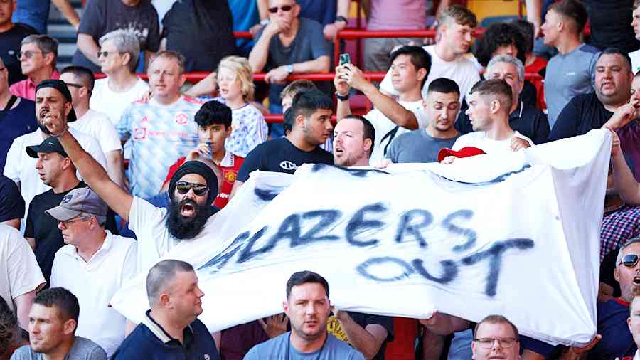 Angry Manchester United supporters display “Glazers Out” banners in protest against the family’s ownership of the club, ahead of the Premier League match at the Brentford Community Stadium in London on Saturday. 